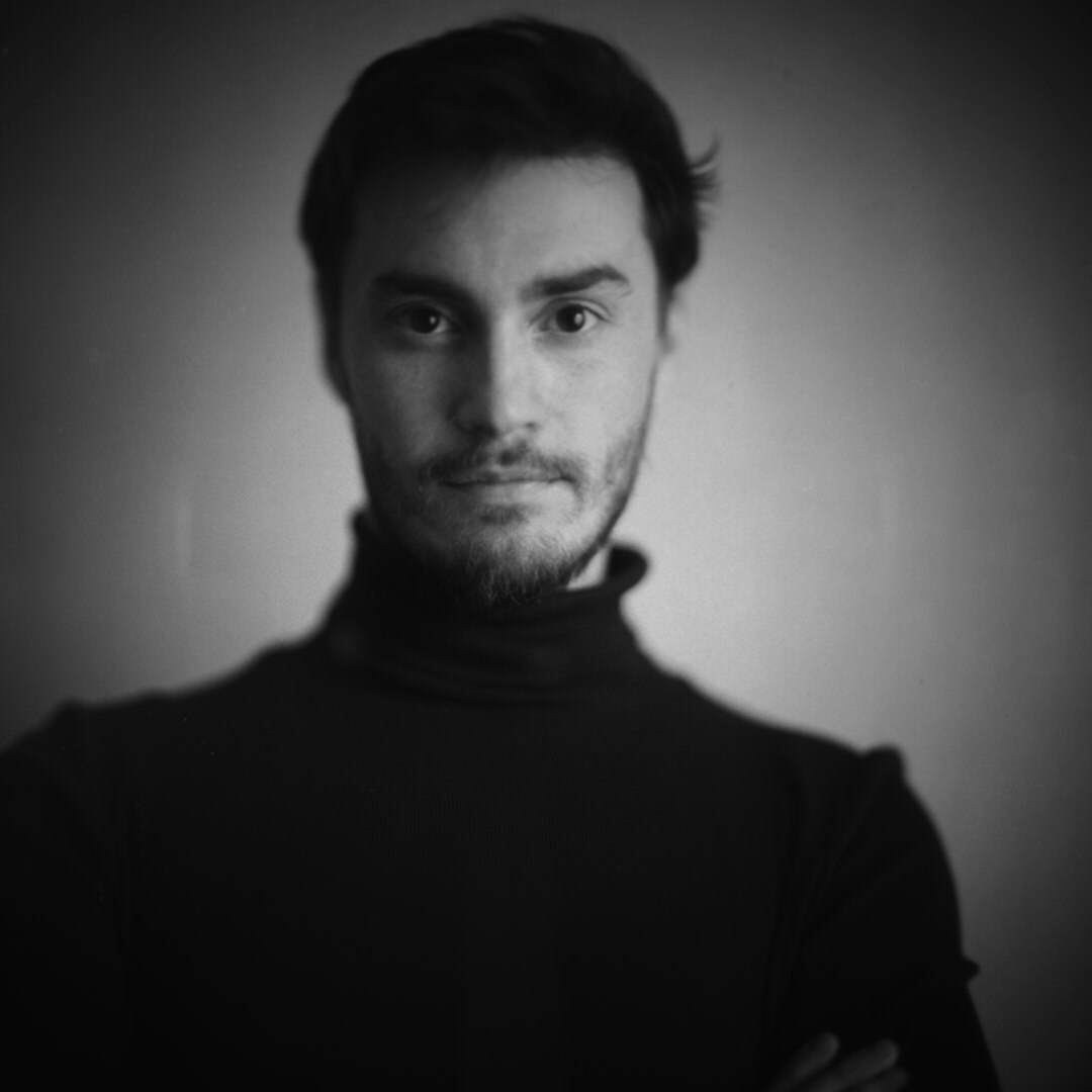 Studio portrait of a male field broadcast technician with a beard